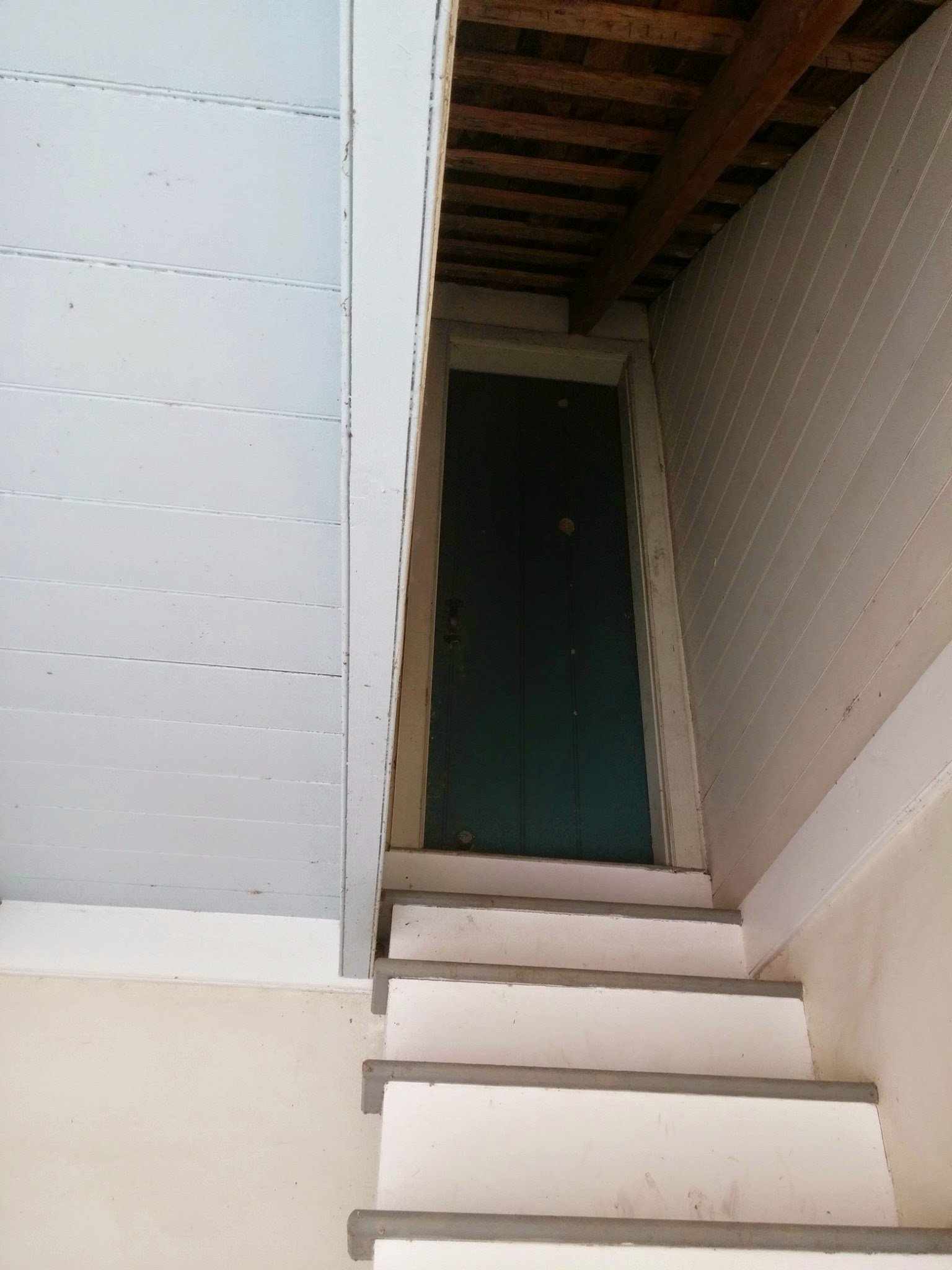 A doorway tucked beneath the roof