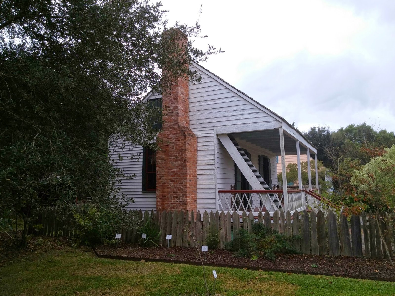 A steep-roofed home with a brick chimney