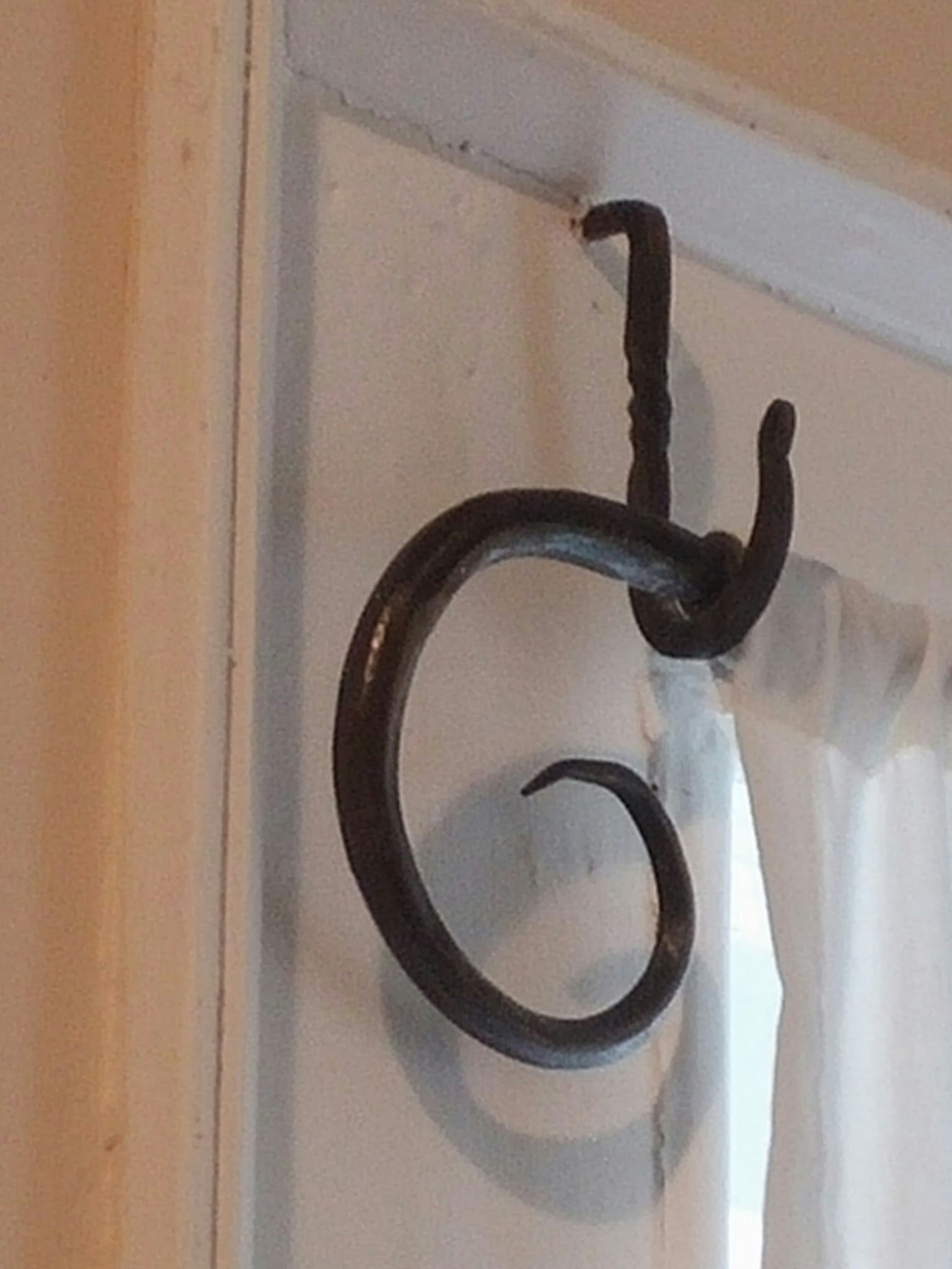 A hand-forged iron hook, an example of blacksmith-made hardware