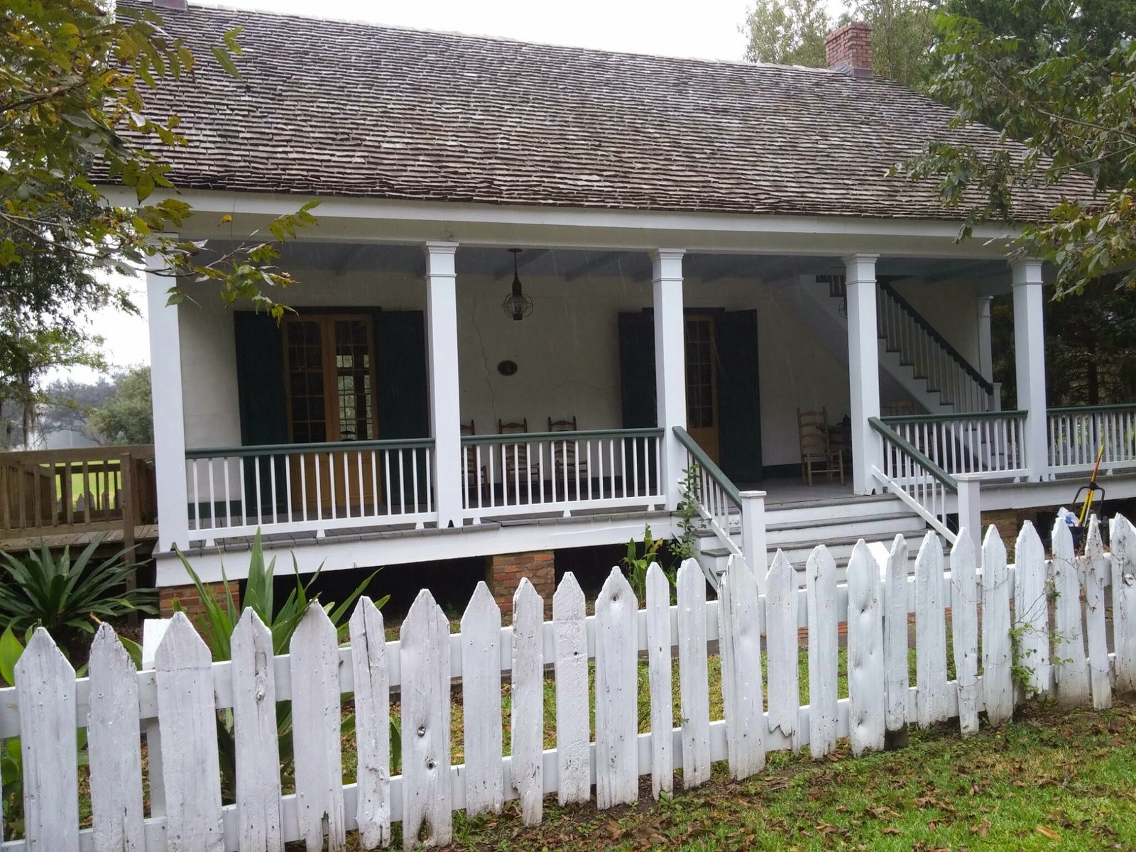 A cottage and white picket fence